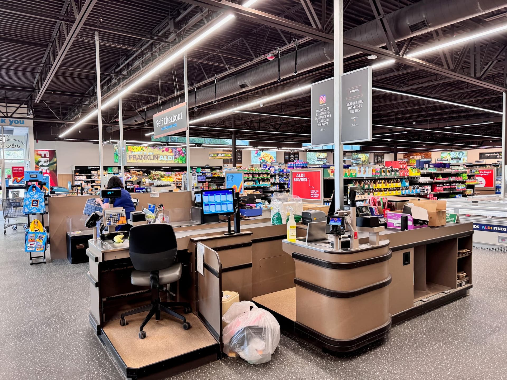 Checkout-lane floor graphics and counter frames, food store in Ķengarags — Ķengarags, Riga